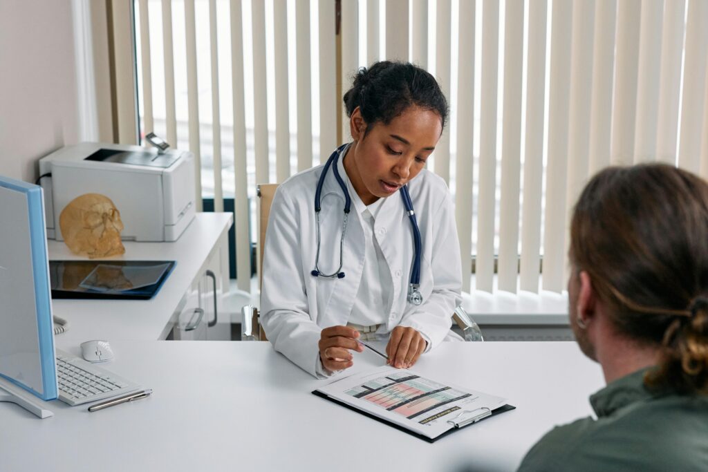zipwp-image-7578803 A doctor consulting with a patient in an office, discussing a medical chart.